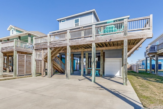 view of front of property with a garage, a wooden deck, and a carport