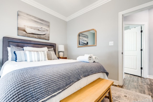 bedroom with crown molding and wood-type flooring