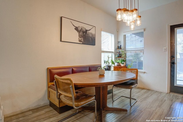 dining area with an inviting chandelier and light hardwood / wood-style floors