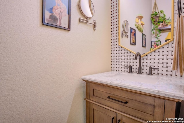 bathroom featuring tasteful backsplash and vanity