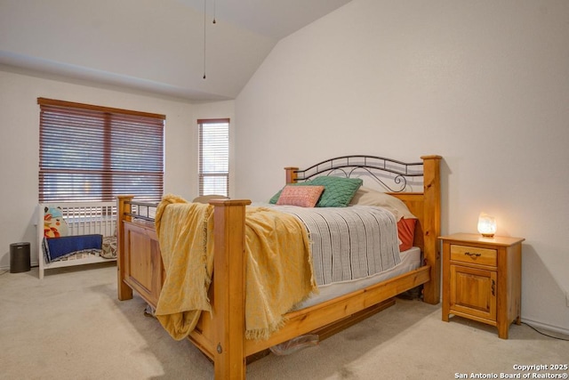 bedroom with light carpet and vaulted ceiling