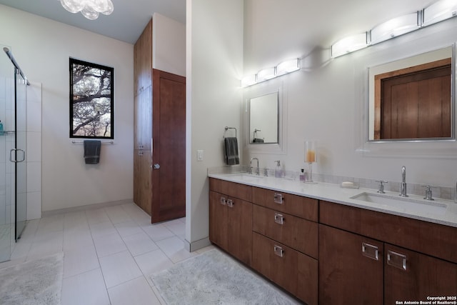 bathroom with vanity, tile patterned floors, and a shower with door