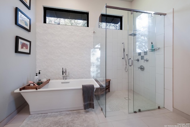 bathroom with separate shower and tub and tile patterned flooring