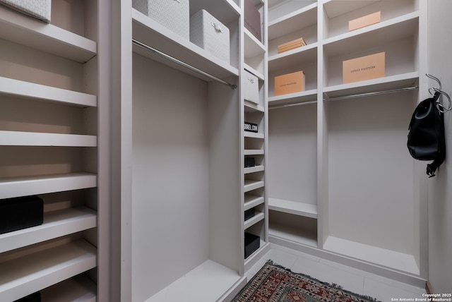 walk in closet with tile patterned floors