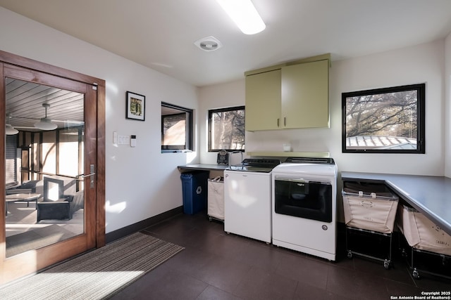 laundry area featuring washing machine and dryer and cabinets