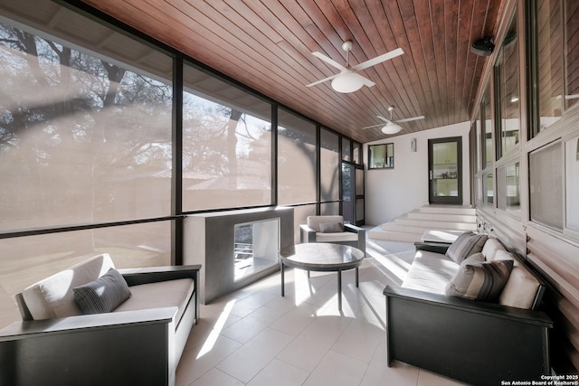 sunroom / solarium with ceiling fan, lofted ceiling, and wood ceiling