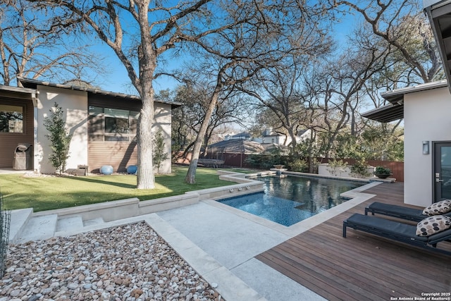 view of swimming pool with a wooden deck and a yard