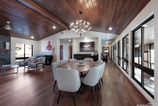 dining room featuring wood ceiling, vaulted ceiling with beams, dark hardwood / wood-style floors, and a large fireplace