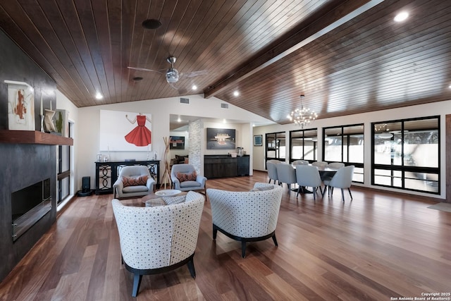 living room with wood ceiling, hardwood / wood-style floors, lofted ceiling with beams, a large fireplace, and ceiling fan with notable chandelier