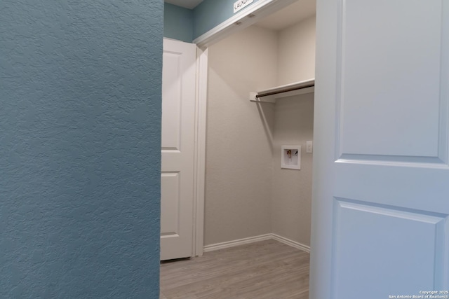 clothes washing area with washer hookup and light hardwood / wood-style floors