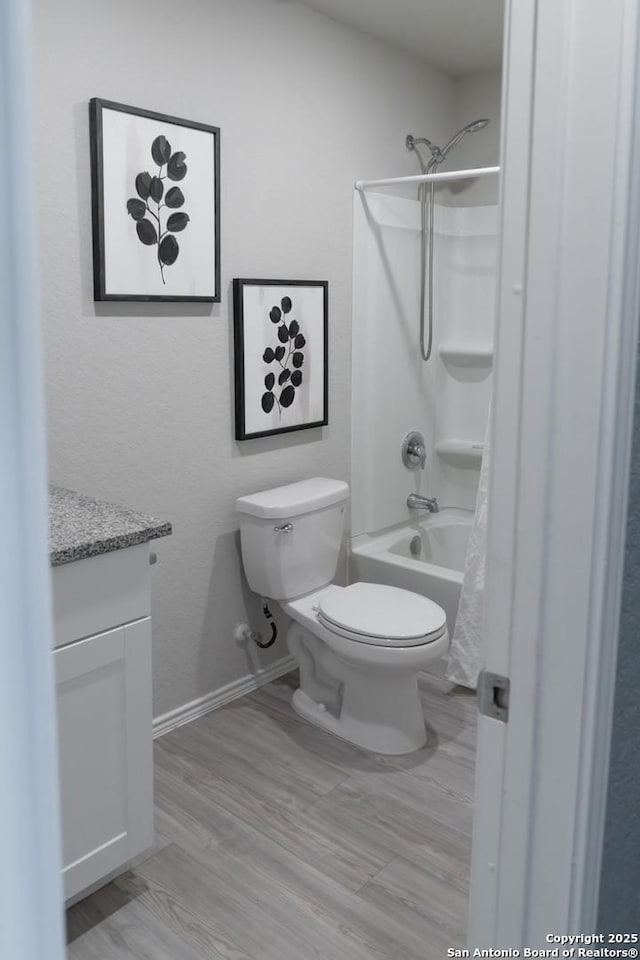 full bathroom featuring shower / tub combo with curtain, vanity, and toilet