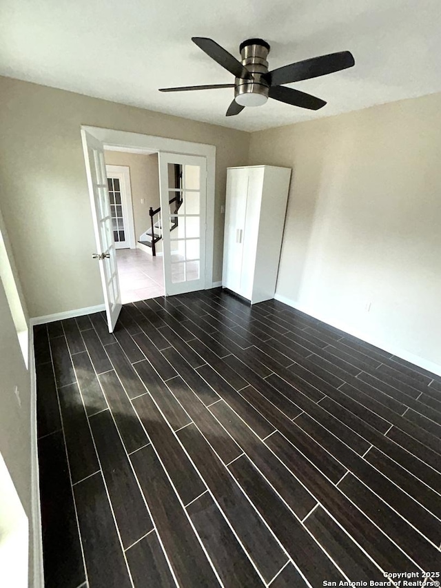 empty room featuring french doors and ceiling fan