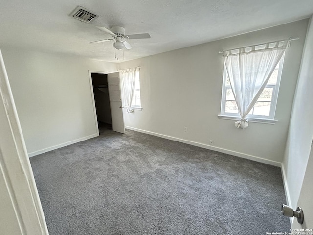 unfurnished bedroom featuring a closet, ceiling fan, carpet floors, and a textured ceiling