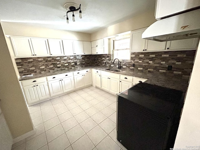 kitchen featuring white cabinetry, sink, tasteful backsplash, and stove