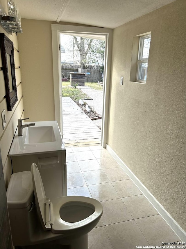 doorway with sink and light tile patterned floors