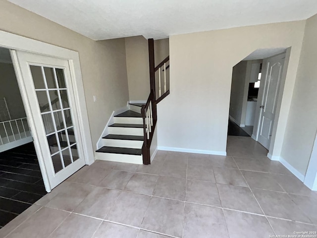 stairway featuring tile patterned flooring