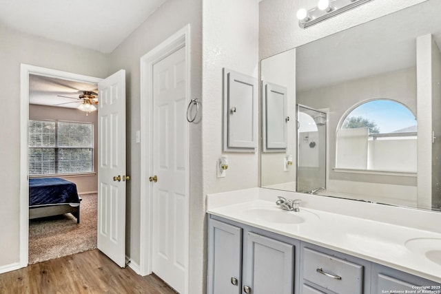 bathroom featuring vanity, hardwood / wood-style flooring, and ceiling fan