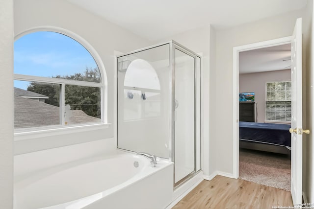 bathroom featuring hardwood / wood-style flooring and shower with separate bathtub