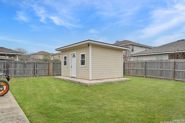 view of outdoor structure featuring a lawn