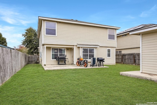 rear view of house featuring a patio and a lawn