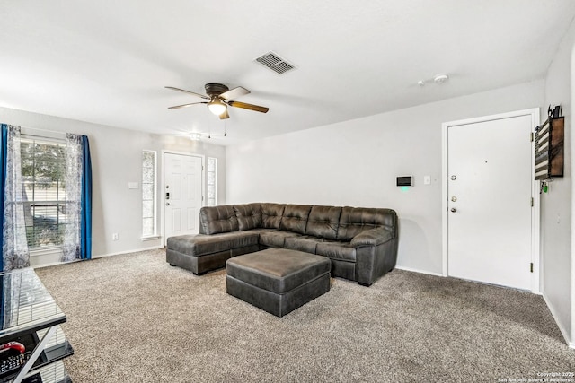 carpeted living room featuring ceiling fan