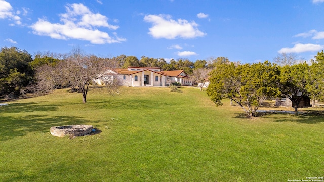 view of yard with an outdoor fire pit