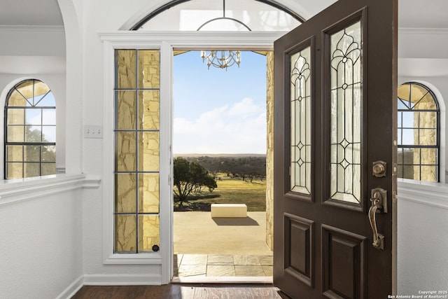 foyer featuring ornamental molding and hardwood / wood-style floors