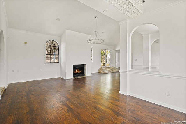 unfurnished living room featuring ornamental molding, lofted ceiling, and dark hardwood / wood-style flooring