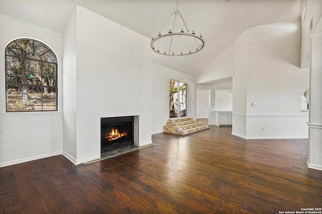 unfurnished living room with ornamental molding, high vaulted ceiling, dark wood-type flooring, and a chandelier