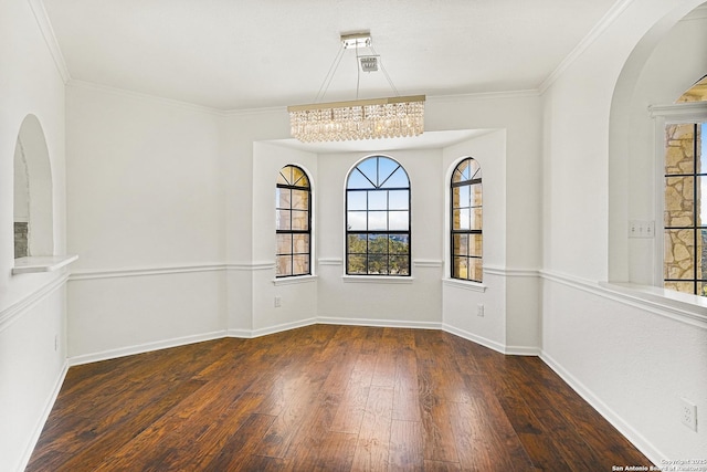 unfurnished room featuring dark wood-type flooring, plenty of natural light, and crown molding