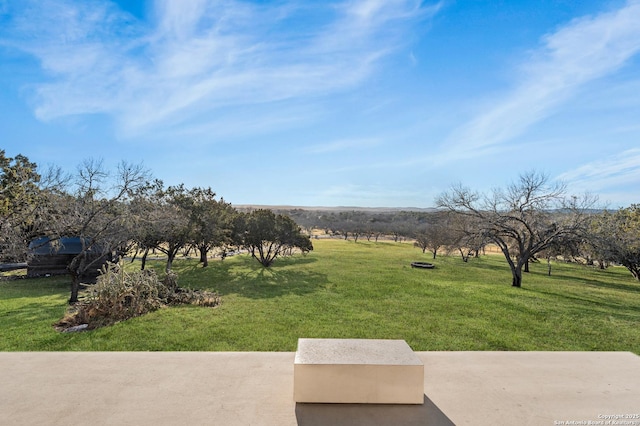 view of yard with a rural view and a patio