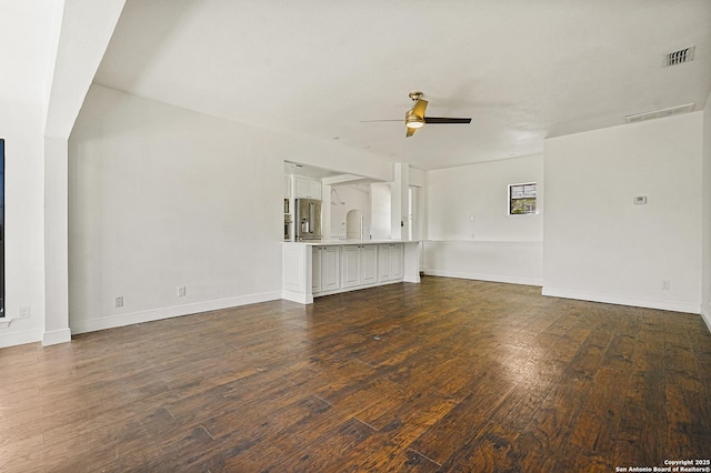 unfurnished living room with dark wood-type flooring and ceiling fan