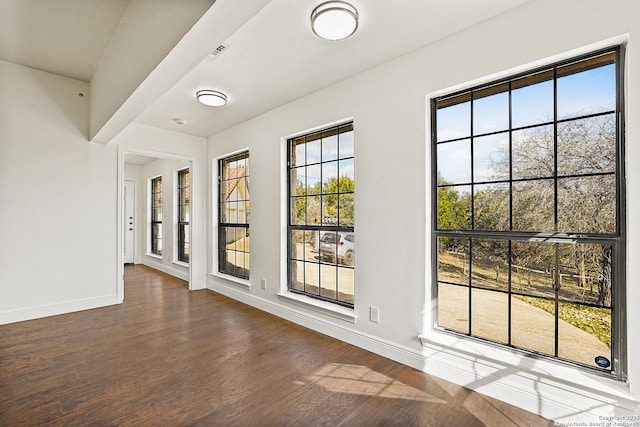 empty room featuring dark hardwood / wood-style flooring