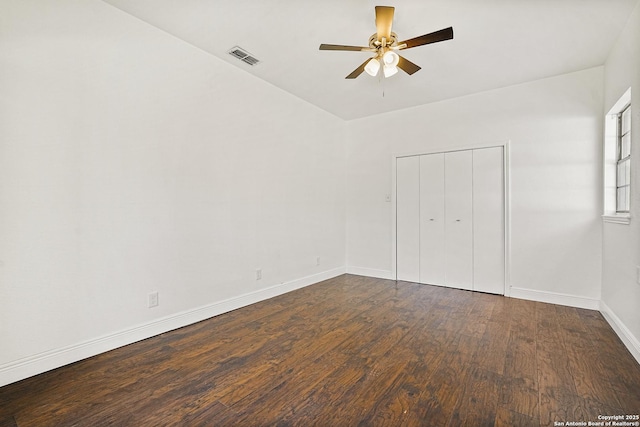 unfurnished bedroom featuring dark hardwood / wood-style flooring, a closet, and ceiling fan