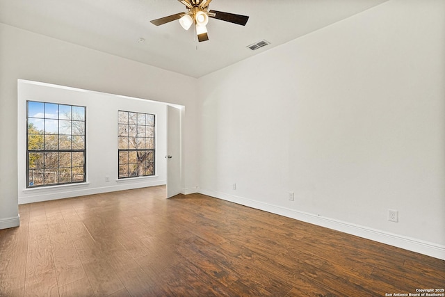 spare room with hardwood / wood-style floors and ceiling fan