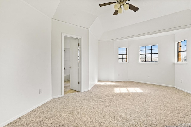 unfurnished room with light carpet, vaulted ceiling, and ceiling fan