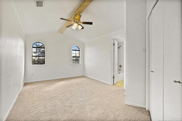 carpeted spare room featuring crown molding, vaulted ceiling with beams, and ceiling fan