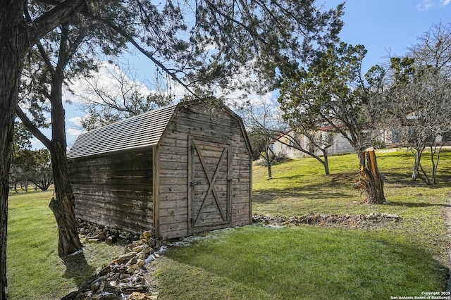 view of outbuilding with a yard