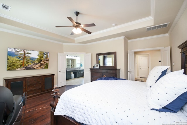 bedroom with a raised ceiling, ornamental molding, dark wood-type flooring, and ceiling fan