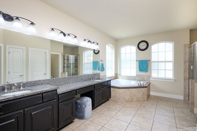 bathroom featuring tile patterned flooring, plus walk in shower, and vanity