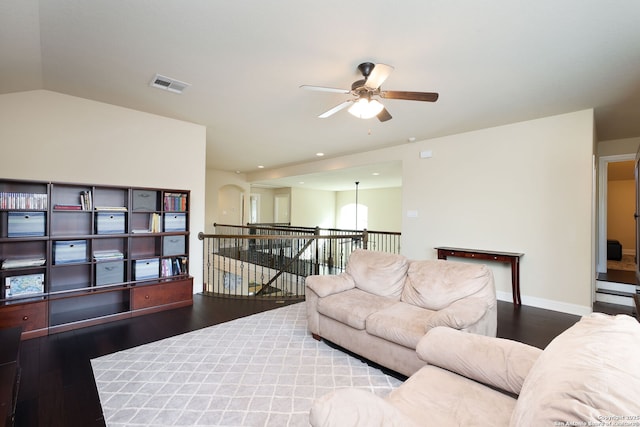 living room featuring hardwood / wood-style flooring, lofted ceiling, and ceiling fan