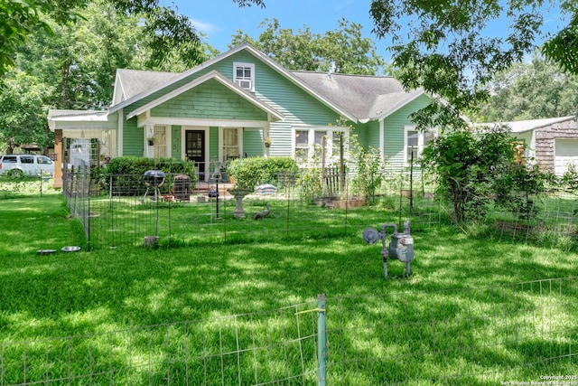 rear view of property featuring a lawn and a porch