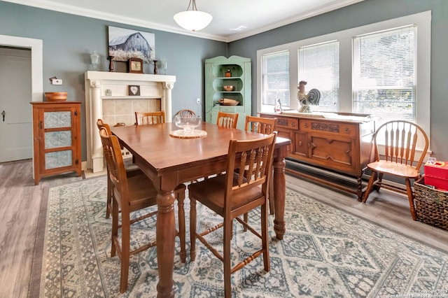 dining space with crown molding and wood-type flooring