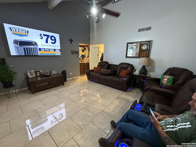 tiled living room featuring ceiling fan, beam ceiling, and high vaulted ceiling