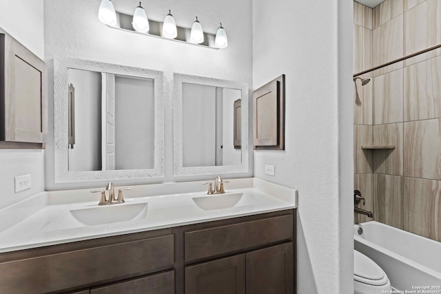 full bathroom featuring vanity, shower / washtub combination, and toilet