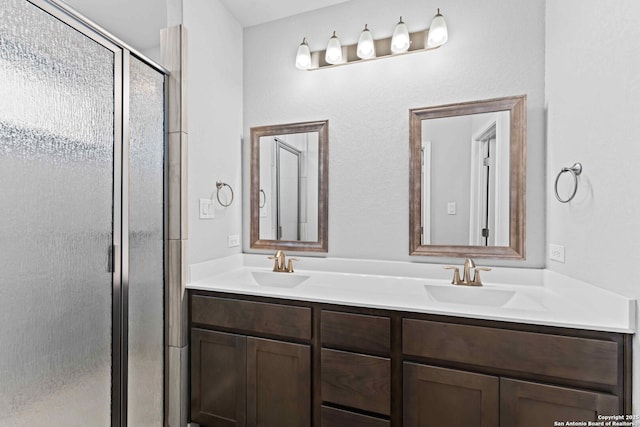 bathroom with vanity and a shower with shower door