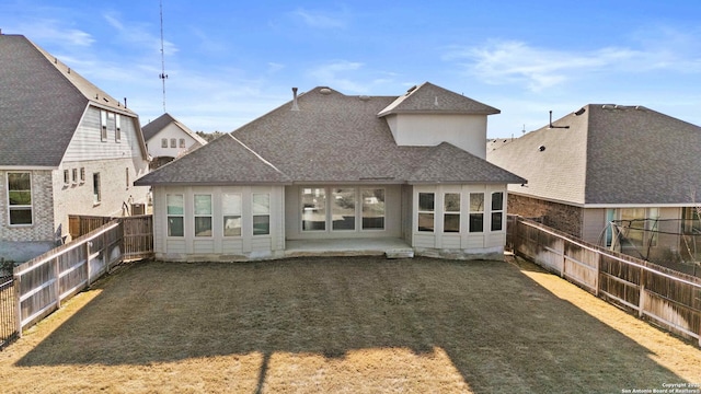 back of house featuring a lawn