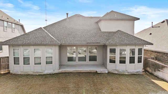 back of property featuring a lawn and a patio area