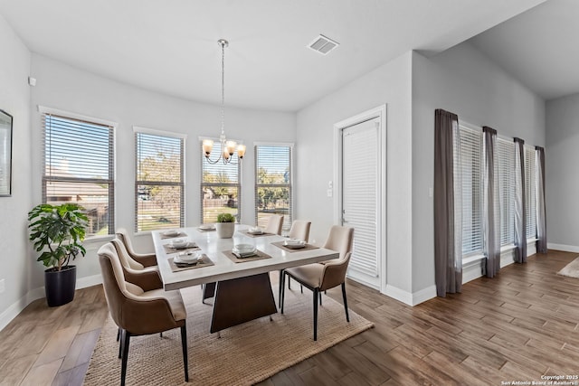 dining room with an inviting chandelier and light wood-type flooring