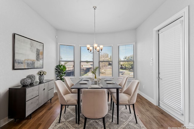 dining area featuring dark hardwood / wood-style flooring and a chandelier